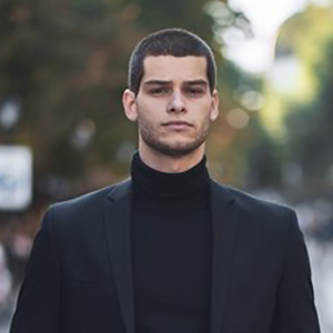 confident-young-man-walking-european-city-street_158595-4692